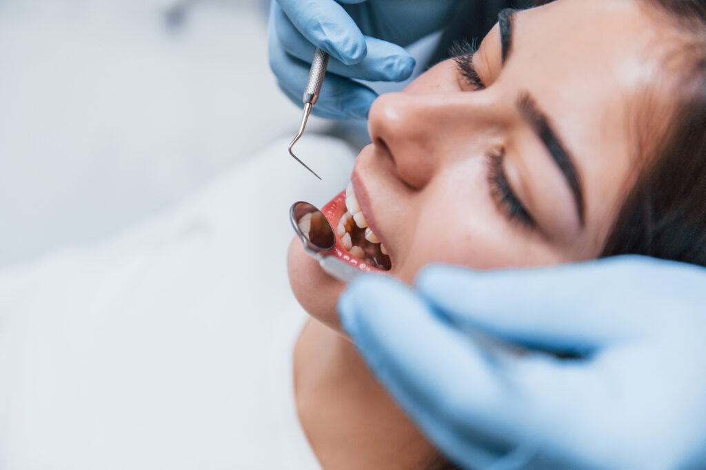 close up view of young adult woman that have a visit in the dentist clinic. conception of stomatology